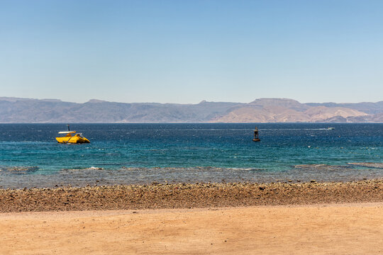 South Beach in Aqaba, Jordan. Egyptian coast near Taba in the beckground