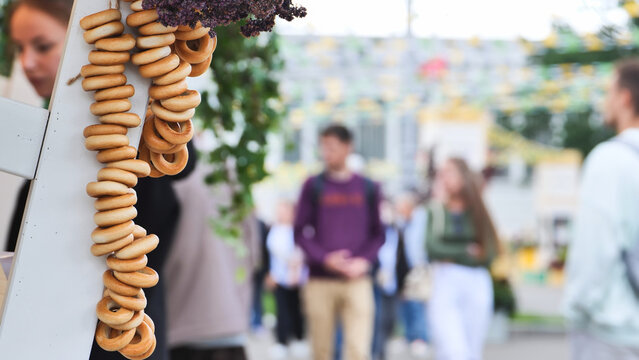 Sushki strings decorating a street market food stall with blurred people