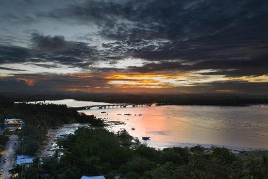 Aerial view of Afam Bridge in Siargao. Long concrete bridge crossing over turquoise water and mangrove forests, scenic coastal infrastructure in the Philippines.