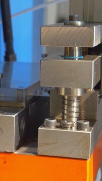 An automatic industrial sheet stamping machine precisely forms metal components in a factory.