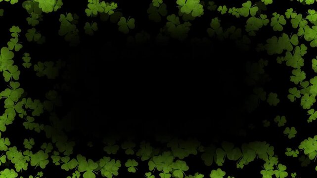 Fresh green clover leaves frame black background with water drops, Green clover leaves adorned with sparkling elements.
Clover leaf particles forming a border for a green background.