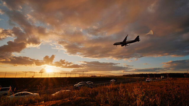 Russian ilyushin il-76 cargo airplane landing at sunset