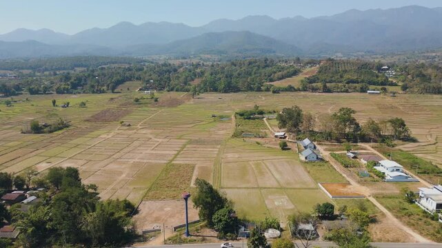 Aerial 4K of green countryside fields in the valley of Pai, Thailand