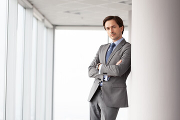 Fototapeta premium A successful businessman stands in an office