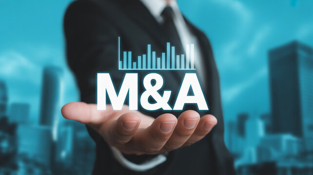 Businessman presenting M& A text and bar graph on his open palm with city skyline background mergers and acquisitions