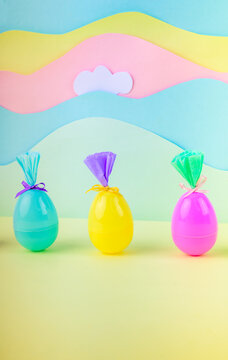 Colorful easter eggs with gift wrapping on pastel background with clouds and rainbow decoration spring holiday concept minimal studio scene.