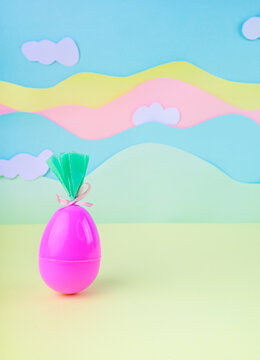 Single pink easter egg with gift wrapping on pastel background with clouds minimal spring holiday concept with copy space