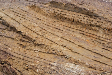 Muddy Offroad Vehicle Tracks in Rural Dirt Road