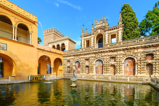 The Mercury Pond or Estanque de Mercurio with a central statue of the Roman god Mercury within the gardens of the Royal Alc&aacute;zar of Seville in Spain. 