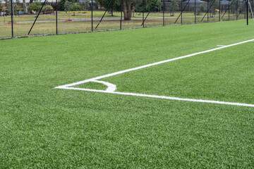 Fototapeta premium Artificial turf sports field in a public park in Australia, featuring a well-maintained synthetic grass surface. Community sports facilities, low-maintenance landscaping, and outdoor recreation