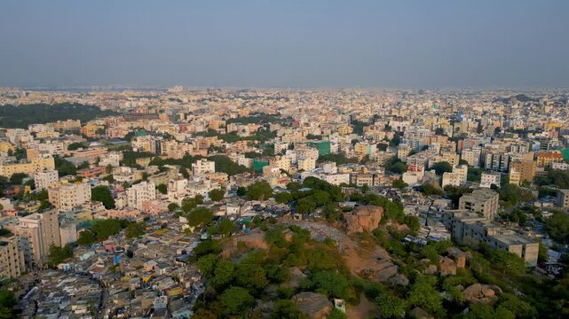 Aerial view of crowded Hyderabad cityscape with apartments and slums