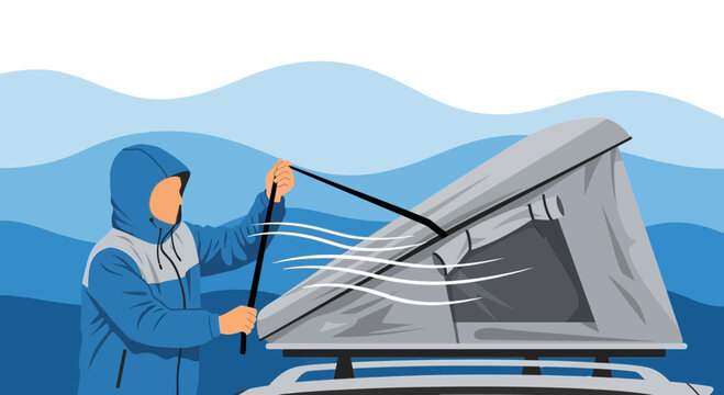 Man Erecting Camping Tent On Vehicle During Windy Weather Adventure