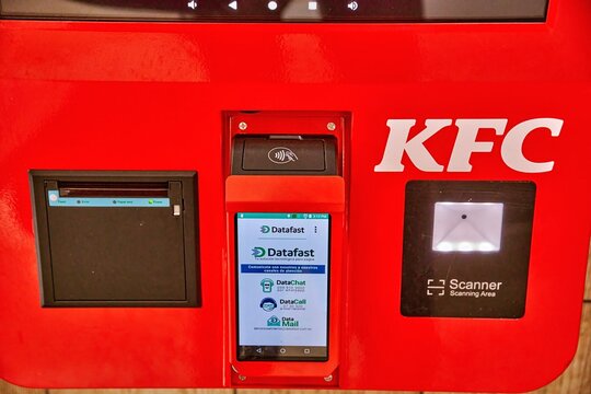 Ambato, Ecuador - June 09, 2025: KFC self-service kiosk featuring touch screen and payment options, showcasing modern technology in fast food dining experience