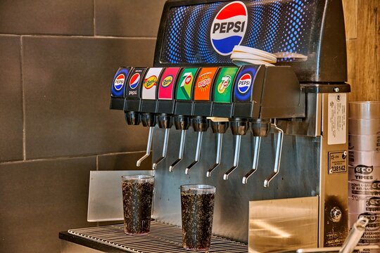 Ambato, Ecuador - June 09, 2025: Pepsi soda fountain machine with multiple drink options at KFC in Mall de los Andes, showcasing vibrant colors and refreshing beverages