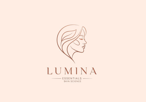 LUMINA ESSENTIALS SKIN SCIENCE Elegant logo design featuring a profile of a woman with flowing hair and subtle leaf accents, symbolizing natural beauty and skincare