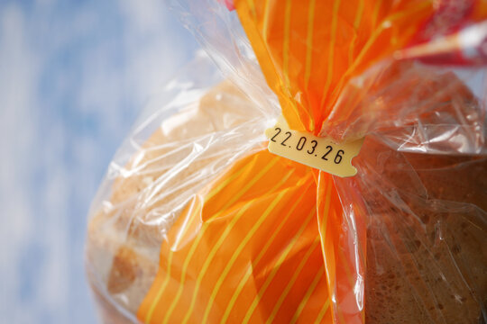 Bread wrapped in clear plastic with an expire date label