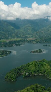 Lake Sebu in South Cotabato, Philippines. Tropical Landscape with blue sky and clouds. Mindanao. Vertical view.