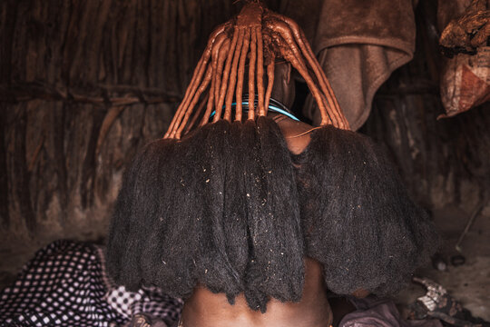 Close-up detail of Himba dreadlocks adorned with red ochre and beads, Southern Angola