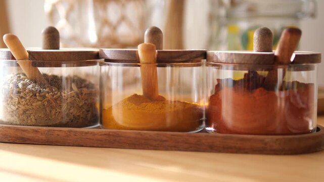 Looking at spice jars on a wooden table