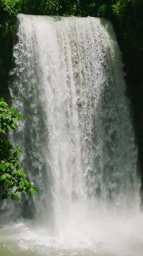 Aerial view of water curtain-like of Hikong Alo Falls in slow motion. Lake Sebu, Mindanao. Philippines. Vertical view.