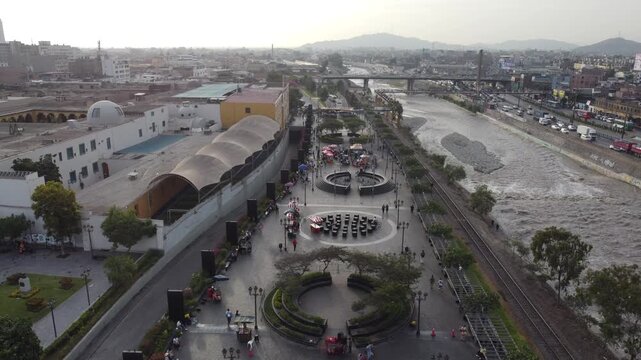 People walking on malecon rimac next to the river in lima, peru