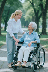 Naklejka premium Vertical shot of young adult woman assisting senior woman with disability in wheelchair, smiling in park. Suitable for elder care, caregiving service, mobility support marketing