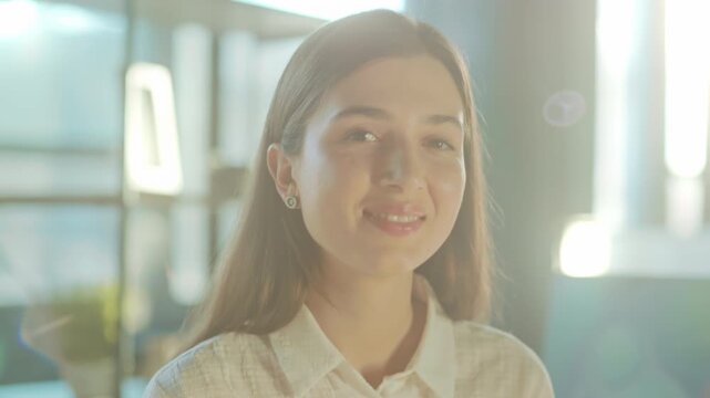 Contemplative female illuminated by warm sunlight, Young lady in serene moment beneath glowing studio light