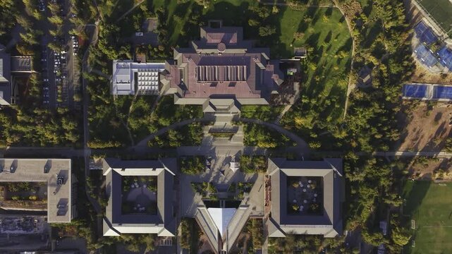 Vertical drone descent toward the main academic buildings and gardens of Universidad de los Andes, San Carlos de Apoquindo, Las Condes, Chile, 4K.