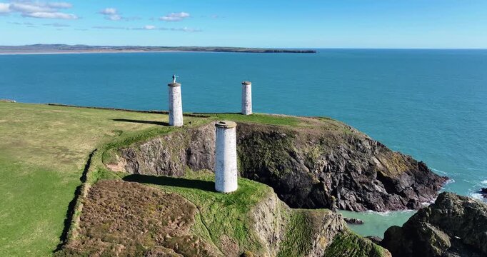 Metalman pillars at the entrance to Tramore Bay With Brownstown Head danger spot for shipping for centuries Tramore Waterford Ireland