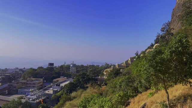 Drone shot of Saptashrungi Devi Temple, a Shaktipeeth nestled in scenic mountain ranges of Vani, Nashik, captured on a bright sunny day with breathtaking aerial views of the sacred hilltop shrine
