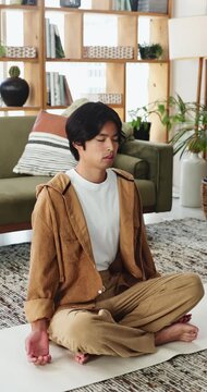 Yoga, man and breathing meditation in home for spiritual healing, inner peace and mindfulness. Yogi, calm person and zen practice on mat for stress relief, holistic wellness and align chakra in house
