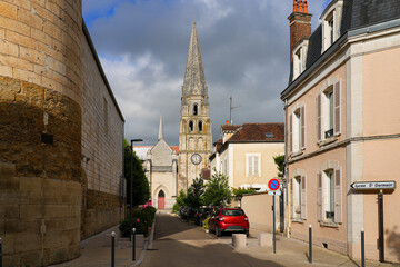 Naklejka premium The Romanesque spire of Saint-Germain Abbey in the historic streets of Auxerre, Burgundy, France