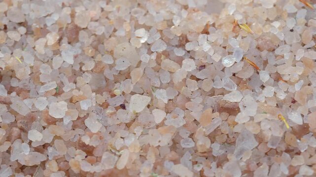 Macro top view of pink himalayan rock salt crystals rotating slowly in high quality cinematic close up footage