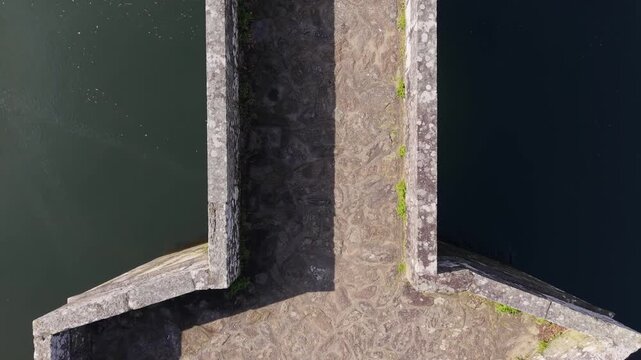 Top View Of Brandomil Historic Stone Bridge In Zas, Spain. Aerial Ascending Shot