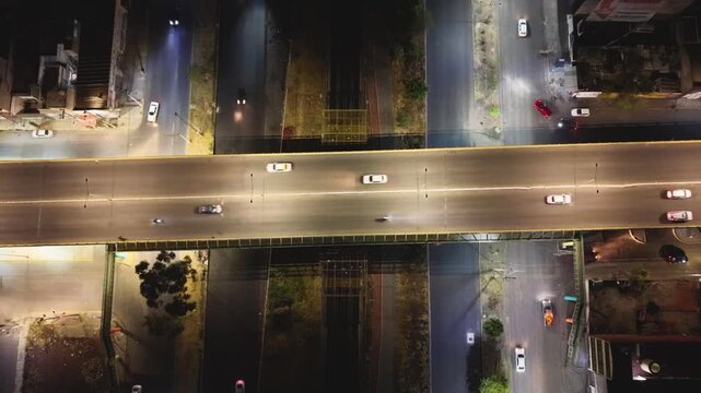 Drone shot of illuminated bridge and moving cars in Ecatepec