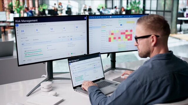 Risk Analyst Carefully Reviews Computer Data