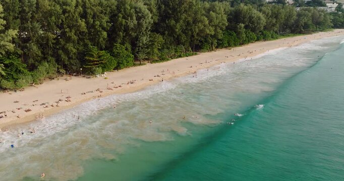 Aerial View Of Nai Thon Beach In Phuket, Thailand, With People On Pristine Coastline. orbiting shot