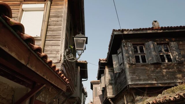 Old wooden houses with tiled roofs and shutters in historic Nessebar Bulgaria