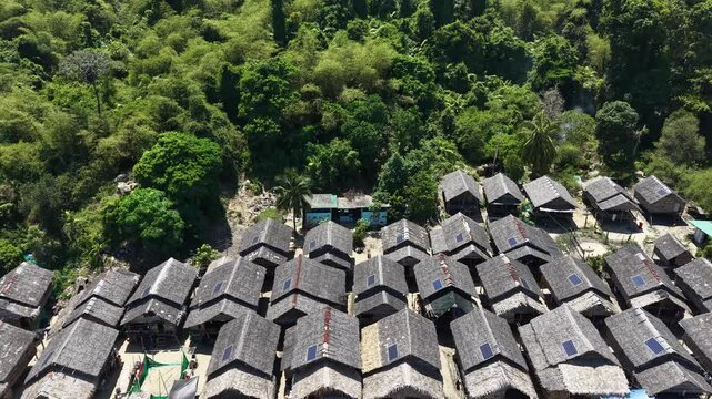 Aerial view of Ko Surin Marine National Park. Traditional long-tail boats and houses of Moken tribe Village or Sea Gypsies and tropical waters of Surin Islands in Thailand, Phang Nga.

