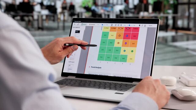 Risk Analyst Carefully Studies Enterprise Report