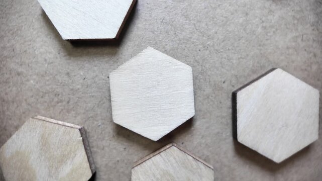 Wooden hexagon shapes arranging into a geometric pattern