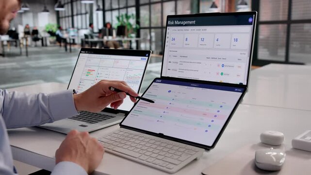 Young Hispanic Man Carefully Tracking OKR Progress