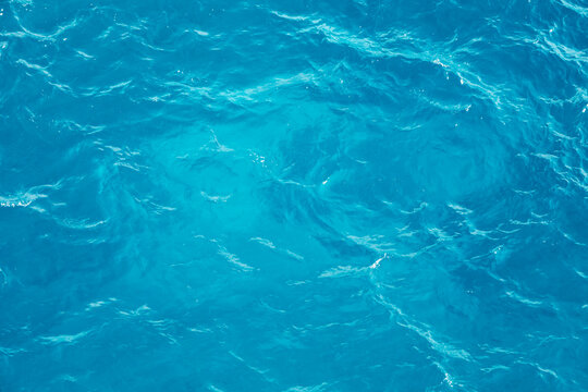 Water moves and swirls in shades of blue creating a liquid background