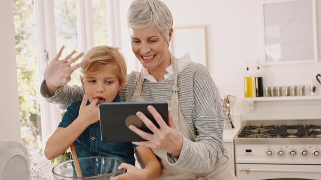 Baking, child and grandmother with tablet for video call, wave or teaching boy in home. Technology, grandma and kid with greeting in kitchen, mix and lick batter with happy family in online chat