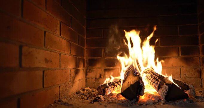 Fireplace with burning wood logs.