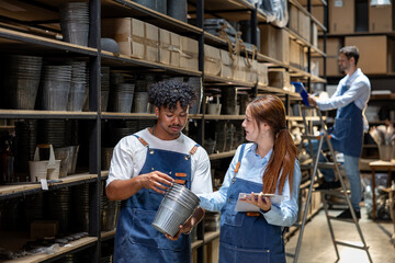 Team of warehouse workers having discussion while checking the storage stock for inventory and merchandise in distribution and shipping logistic center concept