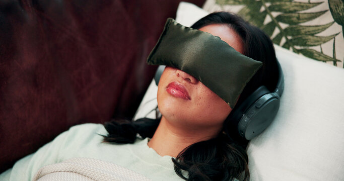 Headphones, therapy and woman on sofa with eye mask for sensory deprivation, microdosing and counseling. Psychology, psilocybin and person with blindfold for treatment, emotion regulation and anxiety