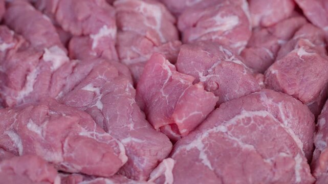 Brightly illuminated image showcasing fresh meat with textured marbling. Highquality photographic depiction of fresh meat arranged on tray emphasizing marbling details