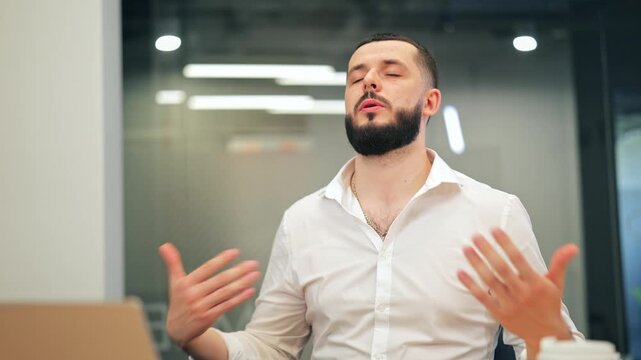 Bearded man in white shirt gasping for air and feeling suffocated during panic attack. Male executive having shortness of breath or anxiety crisis at office desk.