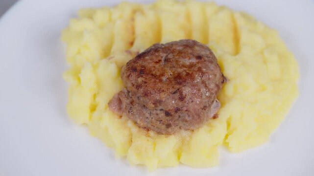 Delicious rustic comfort. Hearty homecooked mashed pork. Golden pork resting on smooth creamy mash. Traditional homemade cutlet atop rich buttery mashed potatoes